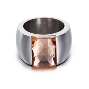 Detail of a wide stainless steel ring featuring a large rectangular amber glass stone