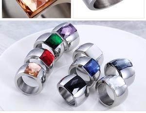 Close-up of square gemstone rings with brushed stainless steel finish in diverse colors