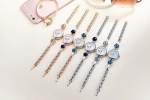 Flat lay of women's quartz bracelet watches with heart clover design and crystal accents
