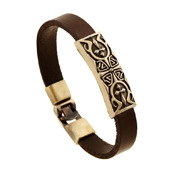 Detailed close-up of brown vintage leather bracelet with bronze celtic lily embossed patterns