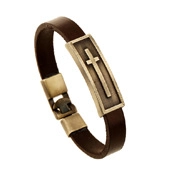 Detail of brown braided leather bracelet featuring a bronze cross plaque and metallic clasp