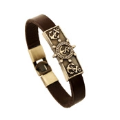Detail of a brown leather punk bracelet with an antique bronze nautical shield plaque