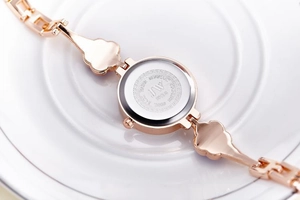 Detailed close-up of rose gold watch case back featuring JW branding and model 5218