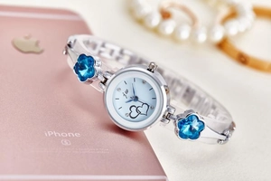 Silver bracelet watch with blue flower crystals and dial shown with elegant pearls