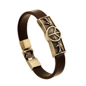 Detail of dark brown leather bracelet with bronze peace sign and bird metal plaque