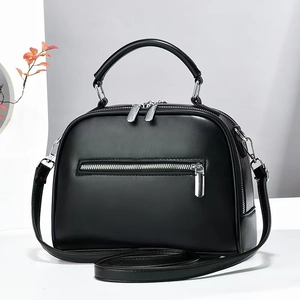 Detail of a large black Boston shoulder bag with dual zippers and silver hardware