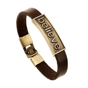 Detail view of brown braided leather bracelet with bronze 'believe' engraved metal plate