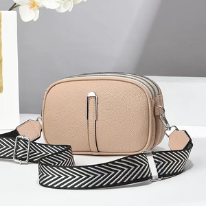 Chic beige mini crossbody bag with three zipper compartments and chevron wide strap
