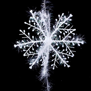 Macro detail of a 3D white glitter snowflake hanging ornament for Christmas window decor