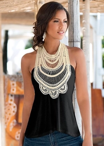 Close-up of black halter top featuring beige crochet lace embroidery on the neckline