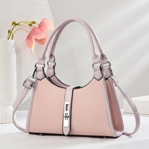 Chic pink canvas patchwork underarm bag with smooth leather trim and silver metal lock