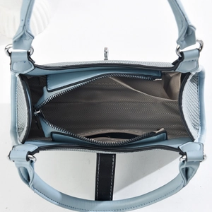 Internal view of blue lychee leather bag with central zipper compartment and silver hardware