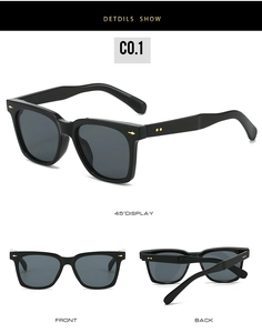 Detail view of black square sunglasses with golden arrow rivets and polished finish
