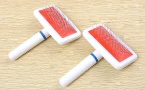 Macro view of double pack pet slicker brushes with curved steel pins for deshedding
