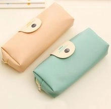 Detail of Korean canvas coin purses in soft orange and mint green for stationery storage