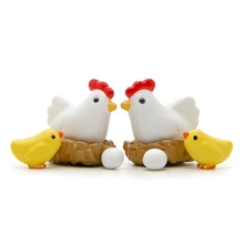 Miniature farm set with white hens, yellow chicks, nests and eggs for desktop decor