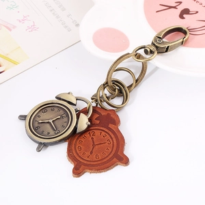 Retro leather keychain with bronze alarm clock pendant and stamped leather tag
