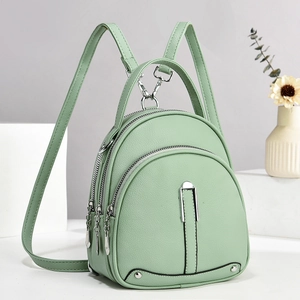 Close-up of mint green lychee grain leather mini backpack with silver metal zippers