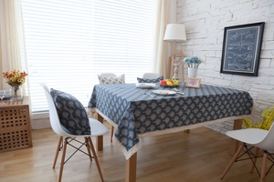 Detail view of navy blue cotton linen tablecloth with white trees and lace trim