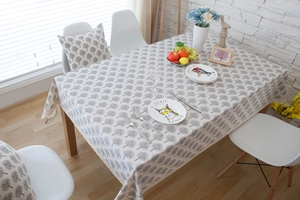 Detailed close-up of grey forest pattern on linen blend tablecloth and matching pillow