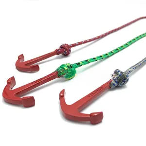 Detailed macro view of red metal Viking anchor pendants with colorful braided cords