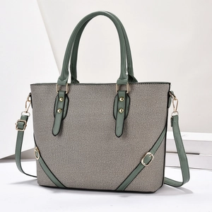 Detail of green leather and grey canvas handbag with gold hardware and strap