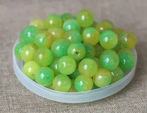 Macro view of green and yellow marbled round beads for handmade jewelry DIY projects