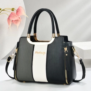 Three-tone panel handbag with vertical texture and golden hardware in stylish 2025 design