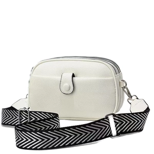 Modern white pebbled leather crossbody bag with dual zippers and chevron strap