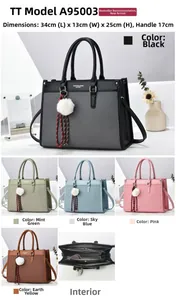 Detailed view of color-blocked tote bag with plush charm and internal zipper compartment