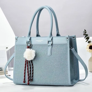 Minimalist light blue woven tote bag for women with fashion lettering and fur ball charm