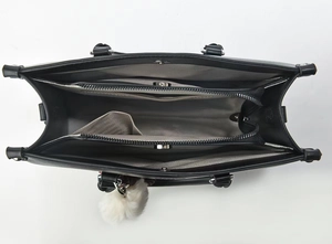 Top view of the spacious black leather bag interior with dual compartments and grey lining