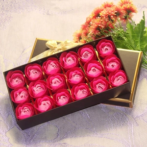 Top view of 18 deep pink soap roses with golden holders in a black gift box