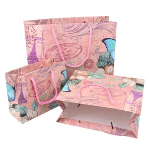 Pink vintage Eiffel Tower paper gift bags in three sizes with floral patterns and handles