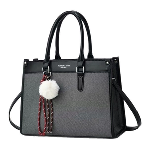 Gray woven tote bag with black leather straps and fashion text on a white background