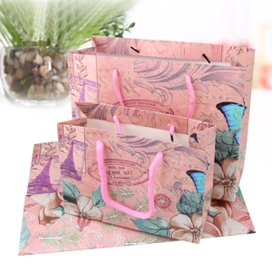 Retro floral Eiffel Tower gift paper bags with pink handles in assorted sizes
