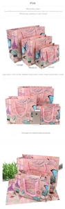 Three sizes of vintage pink gift bags with Eiffel Tower floral patterns and braided handles