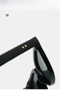 Detail of black sunglasses frame with two gold star rivets on high-elastic temples