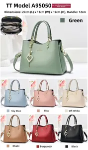 Close-up of elegant PU leather handbag with heart pendant and internal storage compartments