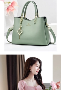 Detailed macro view of mint green handbag featuring heart pendant and pearl charm