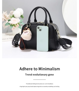 Litchi texture black handbag with geometric wide strap and cute cat plush charm detail