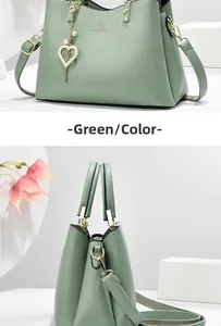 Close-up of green PU leather handbag featuring lychee texture and heart pearl pendant