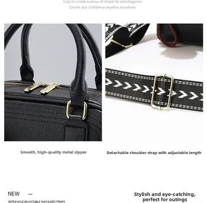 Detail of lychee pattern leather tote with golden double zippers and woven shoulder strap