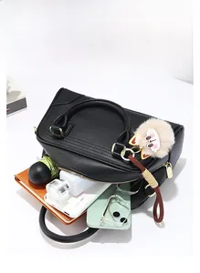 Spacious black litchi leather handbag with golden hardware and cute fox charm