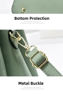 Close-up of sage green textured leather bag showing protective studs and golden hardware