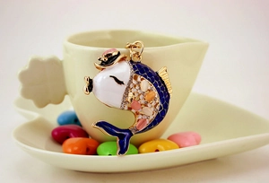 Detailed close-up of fish-shaped keychain with colorful rhinestones and blue enamel fin