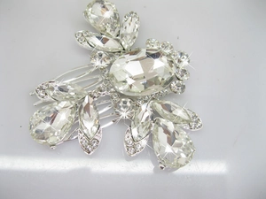 Macro shot of silver bridal hair comb with large teardrop crystals and sparkling rhinestones