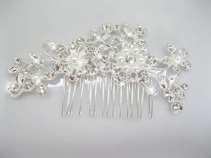 Detail shot of silver bridal hair comb with rhinestones and white imitation pearls