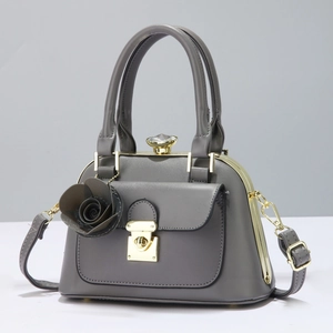 Elegant grey leather handbag with crystal top handle and rose charm detail