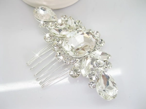 Macro detail of silver bridal hair comb with shimmering rhinestones and metal teeth